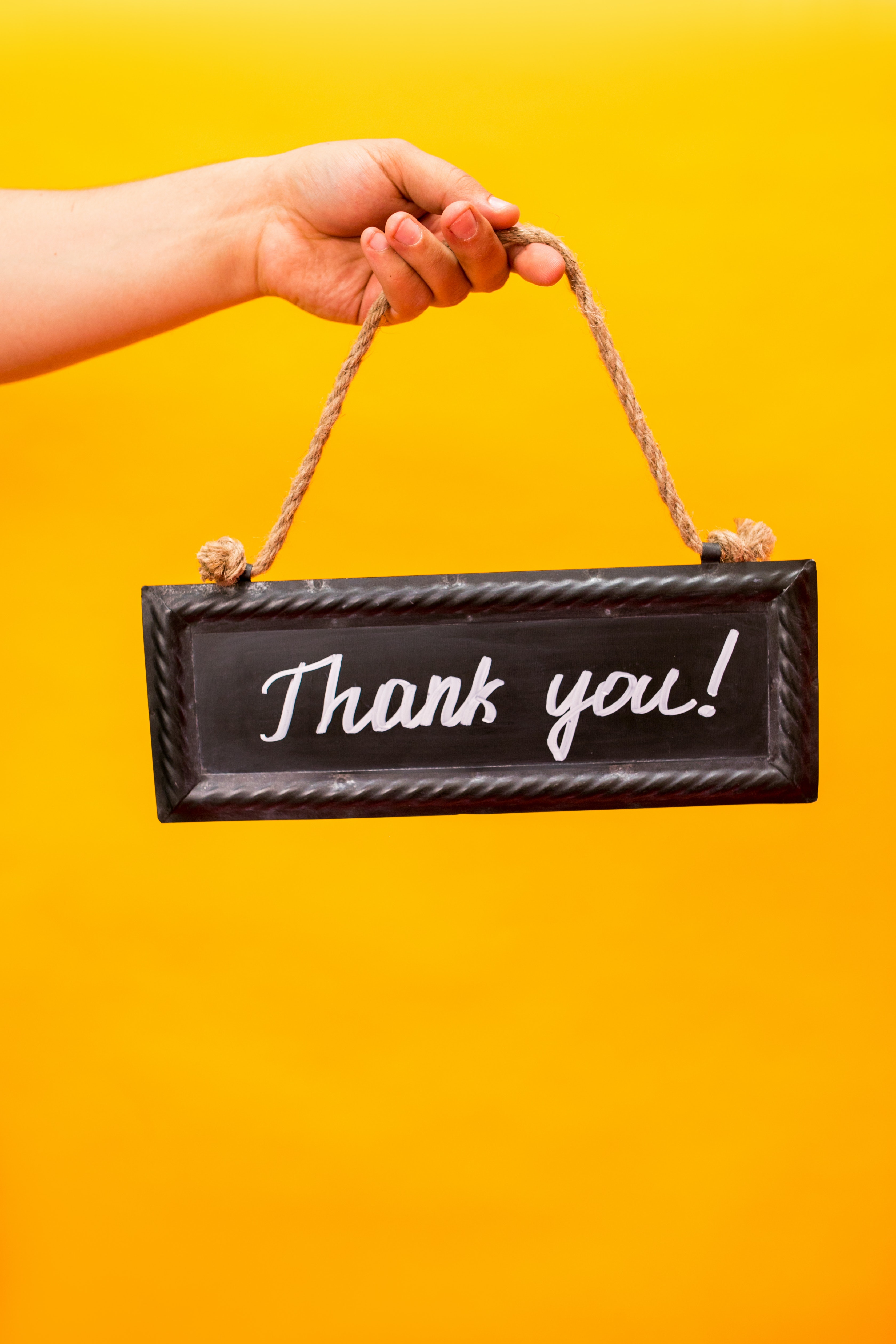 hand holding thank you sign